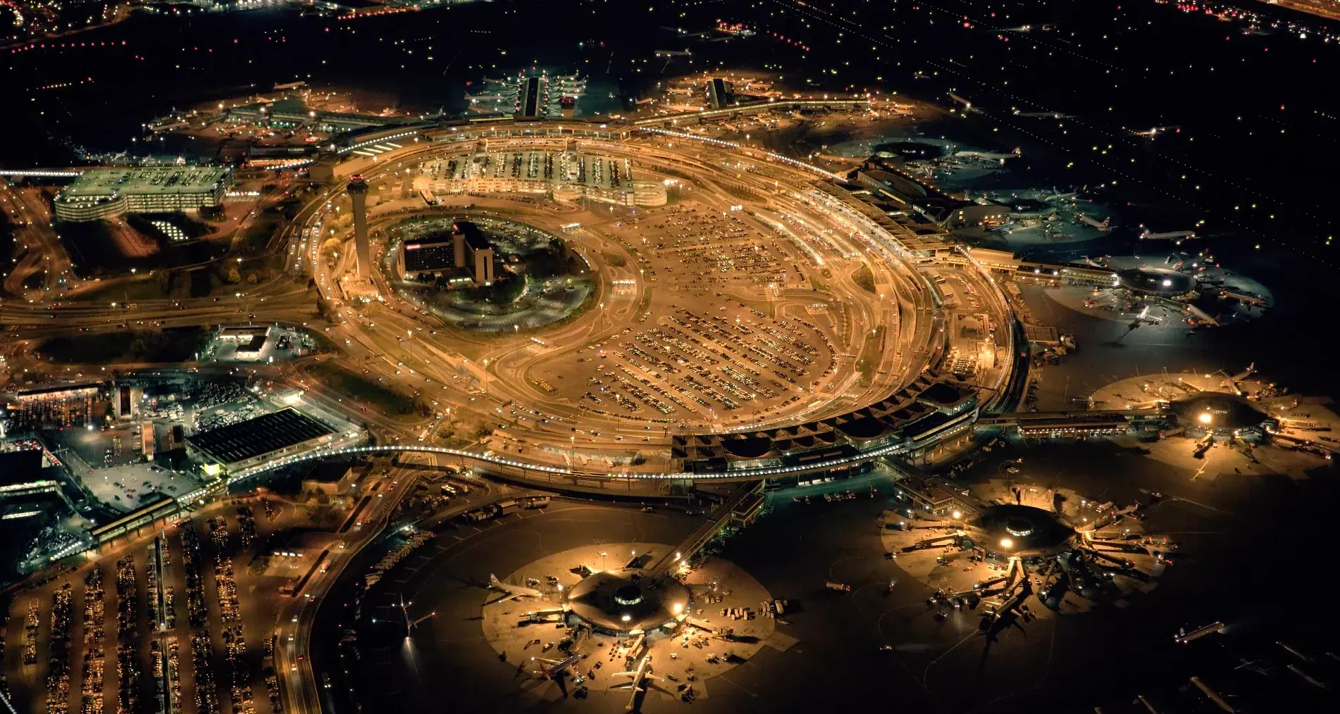 A major international airport illuminated at night.